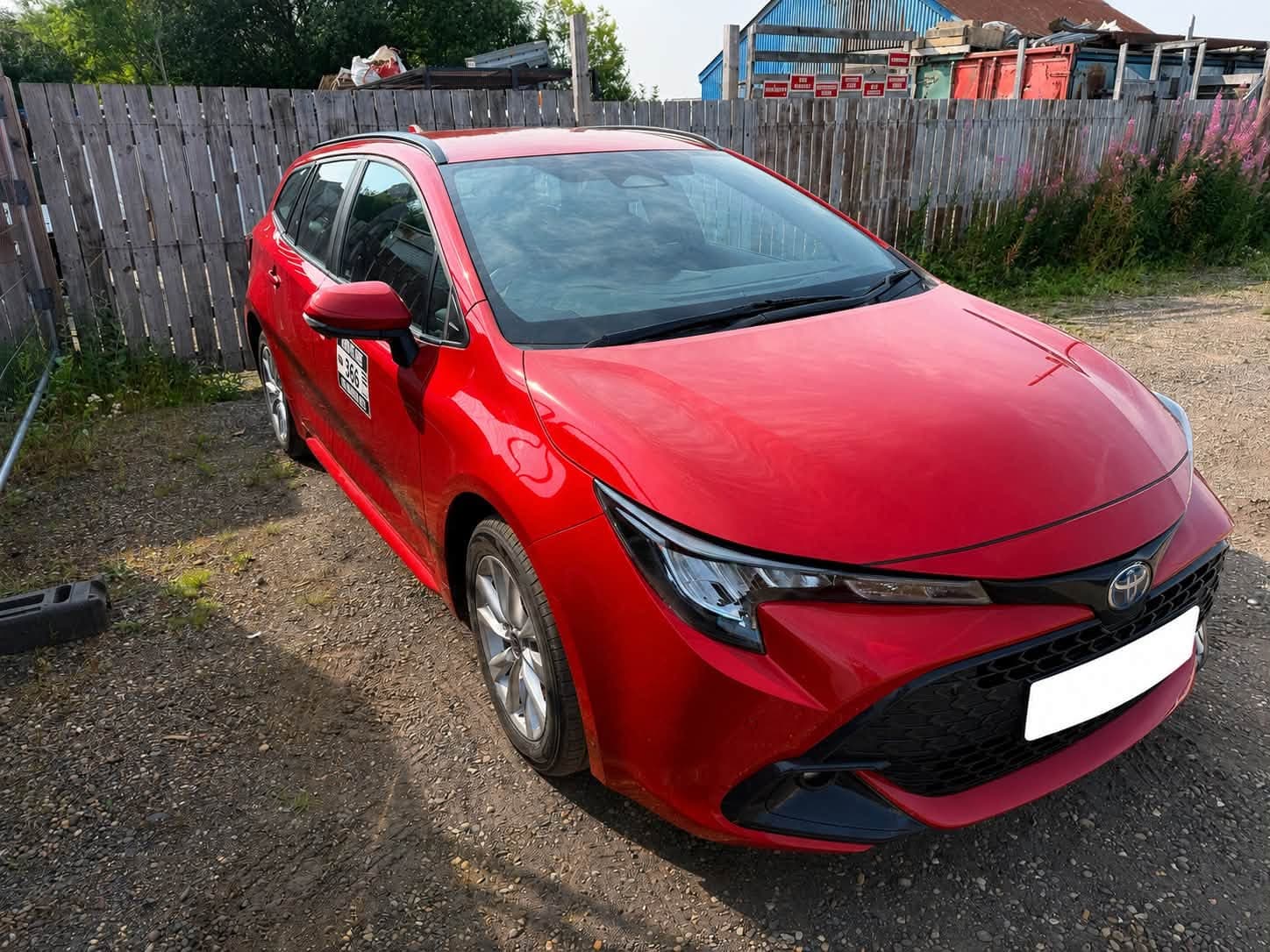 Red Toyota hybrid private hire vehicle from the Red Kite Rentals fleet